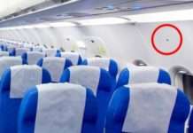 Приховане значення трикутних наклейок над сидіннями в салоні літака